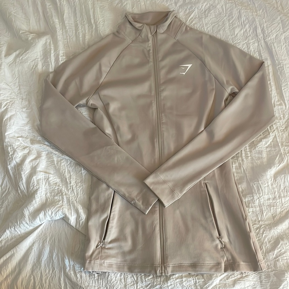 Gymshark full length zip up. Beige/ Stone color. Xs. Never worn.
